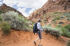 Active Senior Woman hiking in a beautiful red rock canyon Royalty Free Stock Photography