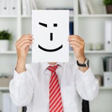 businessman-holding-wink-smiley-front-his-face-mature-office-31196464.jpg