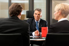 Lawyer or notary with clients in his office Royalty Free Stock Images