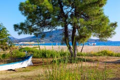 Sea water and sandy beach with boat Stock Images