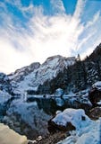 Snowy mountain lake with mountains and blue sky Royalty Free Stock Photo