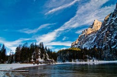Snowy mountain lake with mountains and blue sky Stock Image